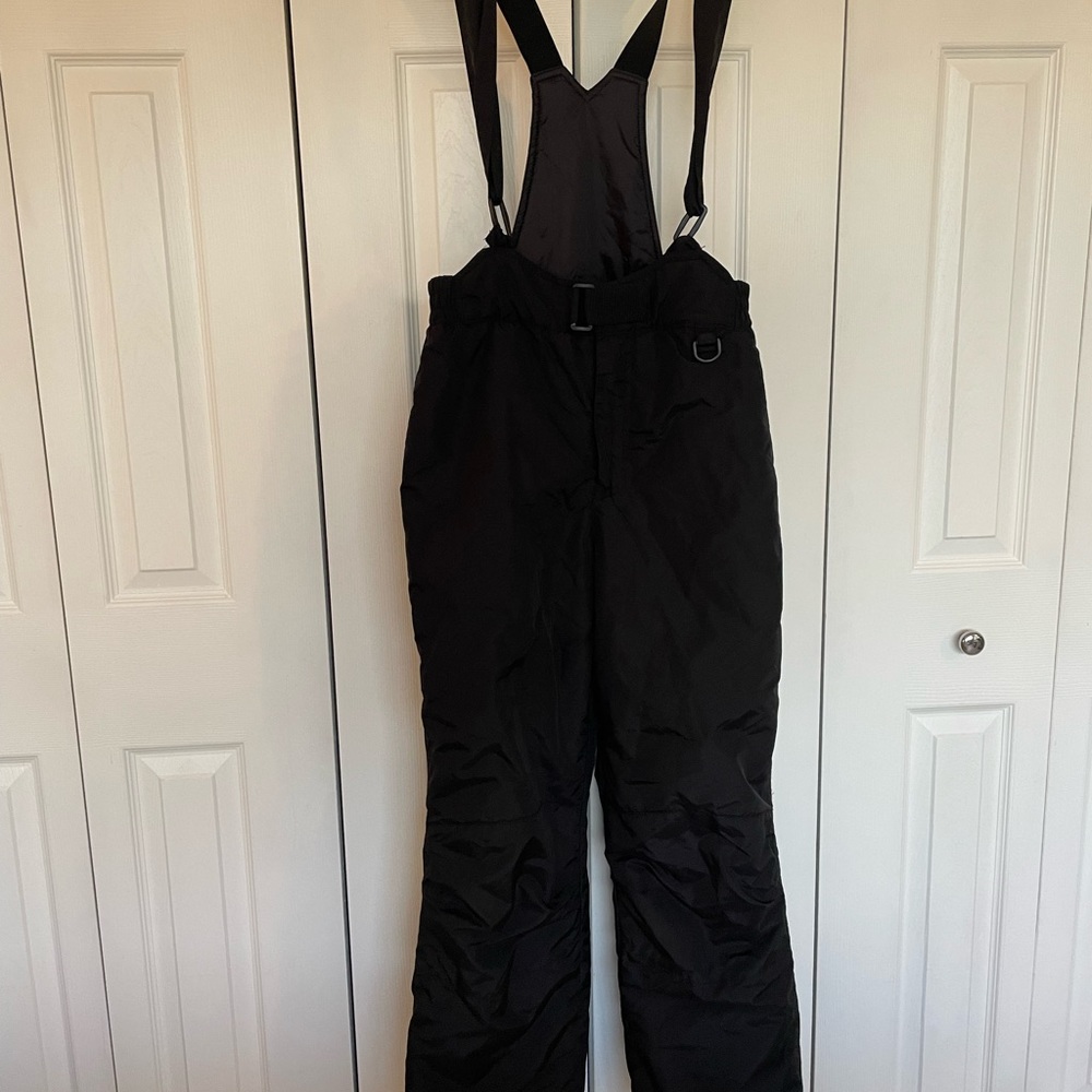 Black overall ski pants.